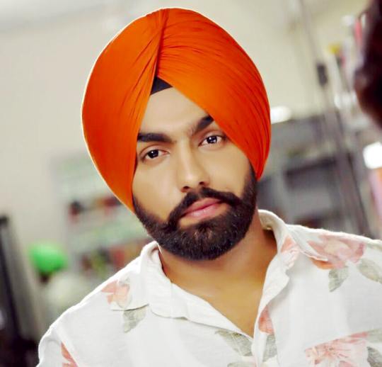 Ammy Virk has made his place in the list of successful Punjabi singers and actors. Today he is touching the heights of fame due to his noteworthy work in music and film industry. Started his career with singing, he moved to acting but never gave up of his singing career. He started his singing career through releasing his first single Ek Pal in 2013. After this he sung many songs and stepped into film industry through blockbuster film Angrej in 2015. After this, he gave hits after hit in film industry like Bambukat, Nikka Zaildar, Nikka Zaildar 2 and many others. His latest film Sat Shri Akaal England was released in 2017. Currently he hasn’t signed any other new film. In this article, you will learn about Ammy Virk Family Photos, about his Father, Mother, Wife, Age, Height, and Biography. Ammy Virk Real Name: Ammy Virk’s real name is Amninderpal Singh Virk but he is famous for his nick name Ammy Virk. Ammy Virk Family Photos: He was born and brought up into a Punjabi Family of Nabha Punjab India. He likes to keep his profile low and therefore he never talked much about his family. We are looking for the details about Ammy Virk Family, as we will come to know we will update it here. So check Ammy Virk Family Photos. Ammy Virk Father and Mother: As I already mentioned that he likes to keep his profile low therefore he talks less about his family. Ammy Virk Father and Mother are still hidden behind the camera. As he will open his mouth about his father or mother, we will update it here soon. Ammy Virk Wife: This versatile singer and actor has not got married yet. According to the rumors, he is in a relationship with Himanshi Khurana. The couple hasn’t confirmed their relationship yet. As he will got marriage or start dating publically, we will update here. Ammy Virk Age: He was born on 11th May in 1992. He is 24 year old and going to celebrate his 25th birthday in 2018. Ammy Virk Height: Ammy Virk has perfect height and weight ratio. He is 5.7 feet tall and has 65 kg weight.